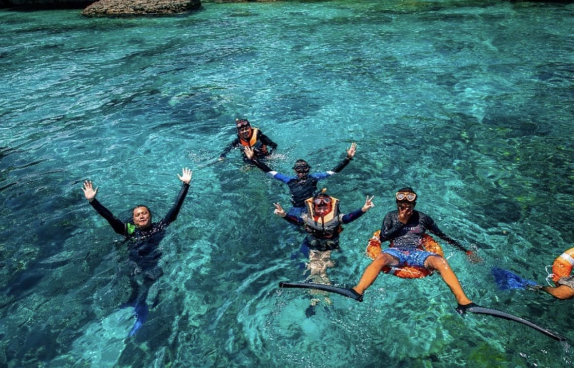 Transparent kayak over crystal clear turquoise water Mantanani Island Sabah